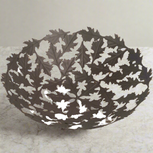 Exquisite Oak Leaf design  metal bowl are handmade from recycled bicycle spokes at artist Khalil Ahmed's workshop, one of many fair trade workshops sponsored by Noah's Ark. Measures 11" in diameter.