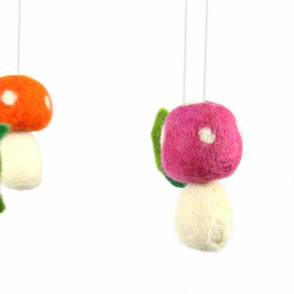 colorful felt mushroom and leaf mobile for baby's or child's room, or whimsical home decor. Handmade in Nepal by fair trade artisans.