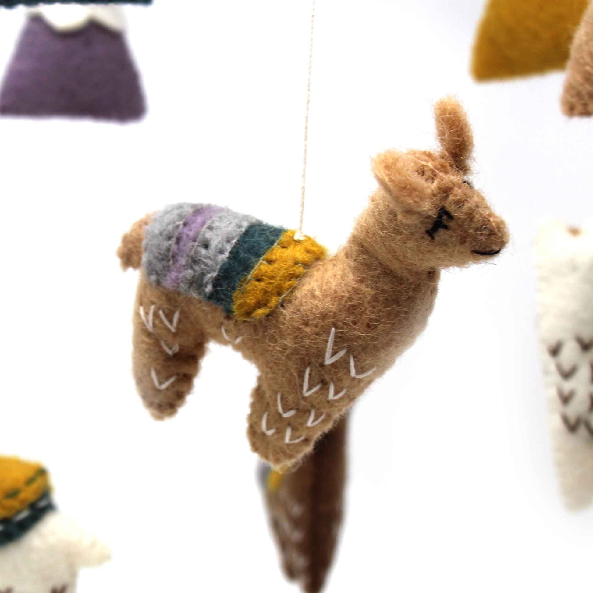 brown felt baby llama hanging from handmade baby mobile using 100 percent recycled wool, fair trade, hand crafted in Nepal.